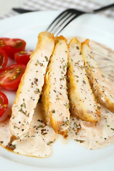 Slices of chicken fillet with spices and cherry tomato on table close up — Stock Photo, Image