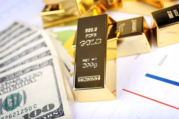 Gold bullion with money on table close up — Stock Photo, Image