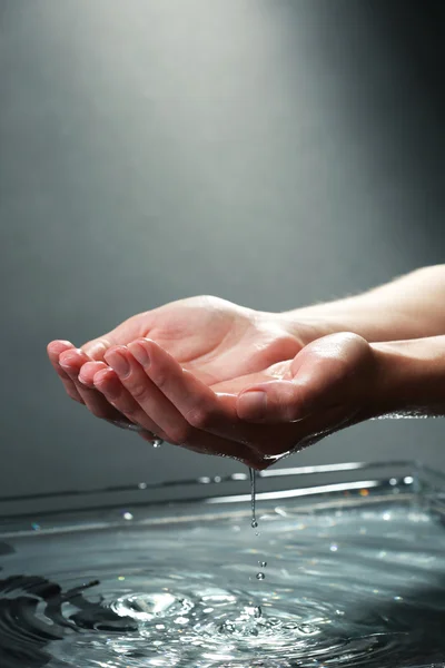 Mains féminines avec éclaboussures d'eau — Photo