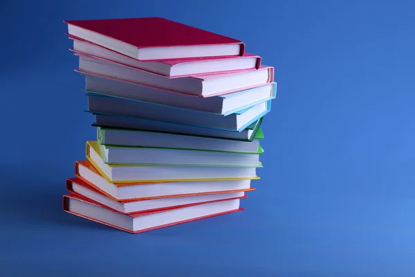 Colorful books on blue background — Stock Photo, Image