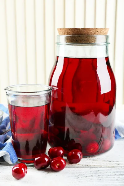 Sweet homemade cherry compote on table, on light background — Stock Photo, Image