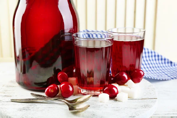 Sweet homemade cherry compote on table, on light background — Stock Photo, Image