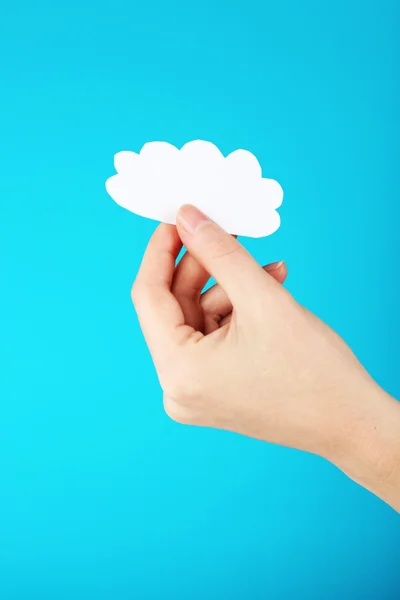 Hand holding paper cloud on blue background — Stock Photo, Image