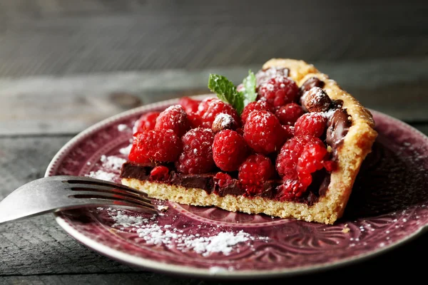 Кусок пирога со свежей малиной, на деревянном фоне — стоковое фото