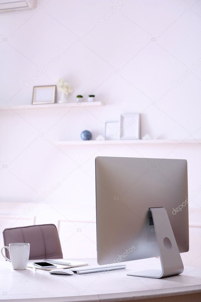 Workplace with computer in room