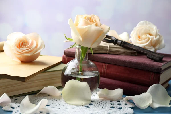 Fresh roses with old book and letters on color wooden table, on bright background. Vintage concept — Stock Photo, Image