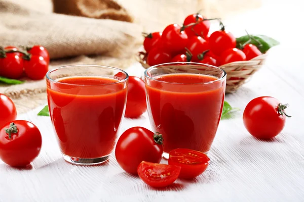 Vasos de jugo de tomate en la mesa de madera, primer plano —  Fotos de Stock