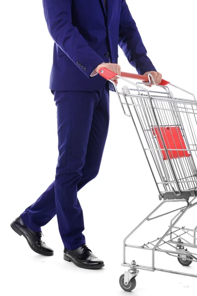 Young man with empty shopping cart, isolated on white — Stock Photo, Image