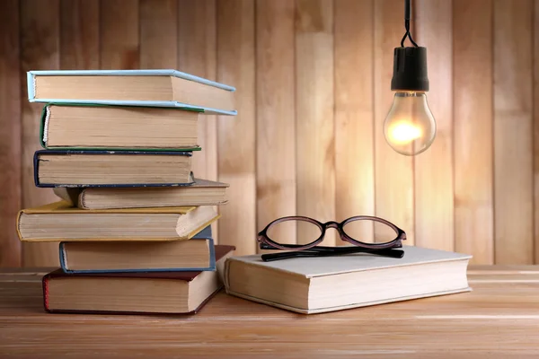 Lightbulb and books — Stock Photo, Image