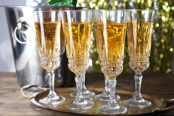 Glasses of champagne on bright background — Stock Photo, Image