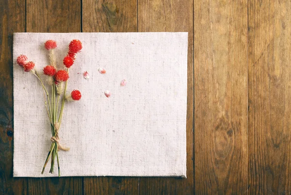 Beautiful dry flowers on napkin — Stock Photo, Image