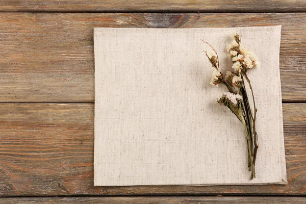 Beautiful dry flowers on napkin — Stock Photo, Image