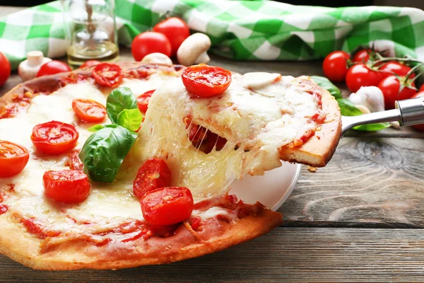 Delicious pizza with cheese and cherry tomatoes on wooden table, closeup — Stock Photo, Image