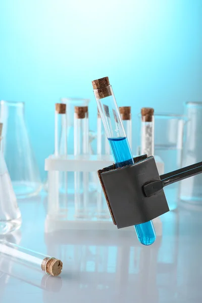 Empty laboratory test tubes on blue background — Stock Photo, Image