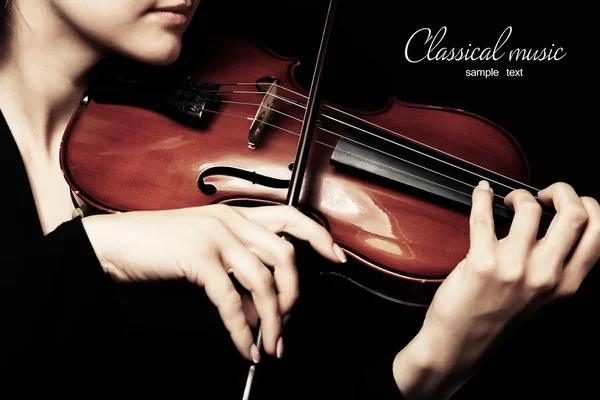 Violinist playing violin on dark background — Stock Photo, Image