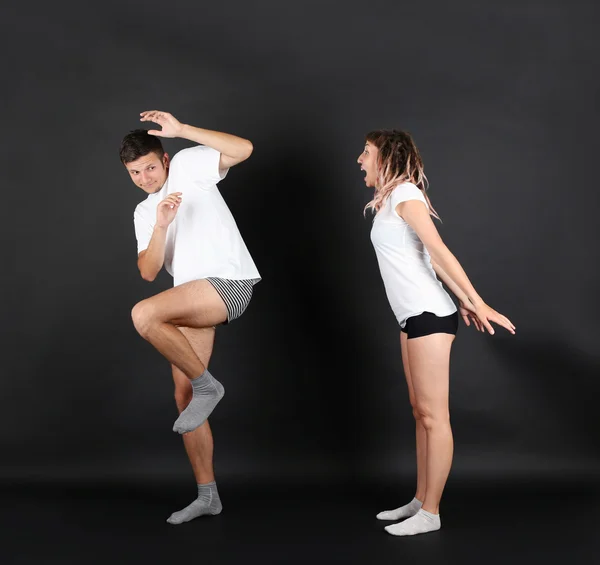 Young couple on black background — Stock Photo, Image