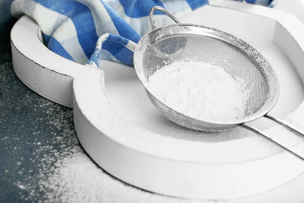 Sifting flour through sieve — Stock Photo, Image