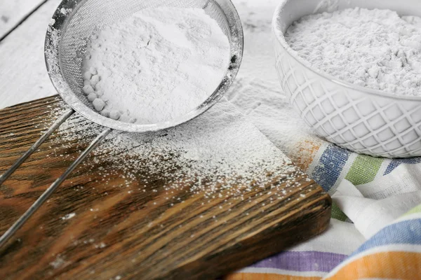 Sifting flour through sieve — Stock Photo, Image