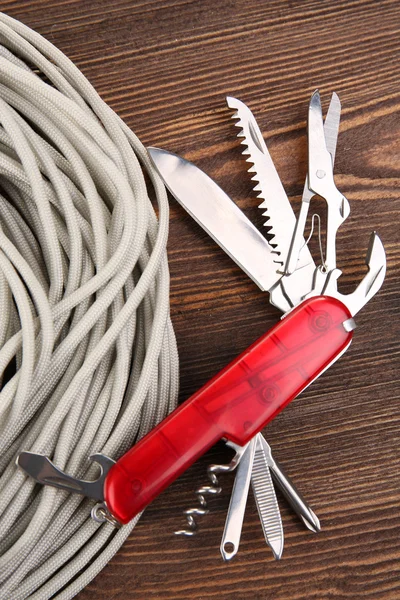 Multipurpose knife on wooden background — Stock Photo, Image