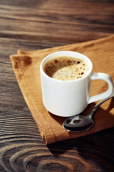 Cup of coffee on napkin — Stock Photo, Image