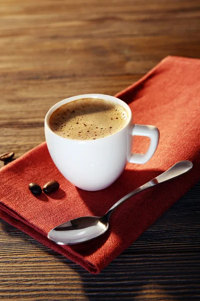 Cup of coffee on napkin — Stock Photo, Image