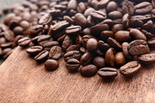 Coffee beans on wooden background