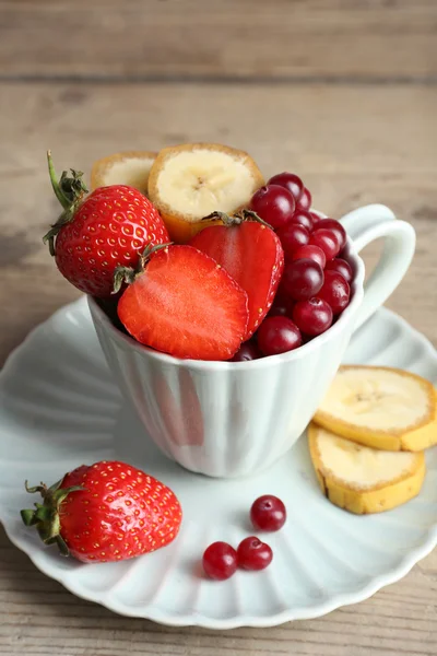 Beker van dessert met vers fruit op houten tafel, close-up — Stockfoto