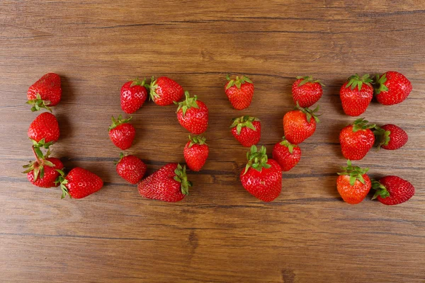 Word LOVE de fraises mûres sur fond de bois — Photo