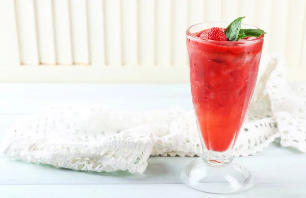 Strawberry dessert with ice in glass, on wooden table, on light background — Stock Photo, Image