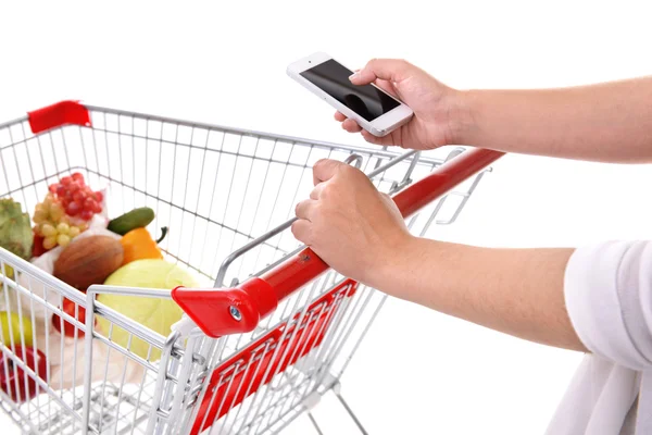 Young woman holding mobile phone and shopping cart close up — Stock Photo, Image