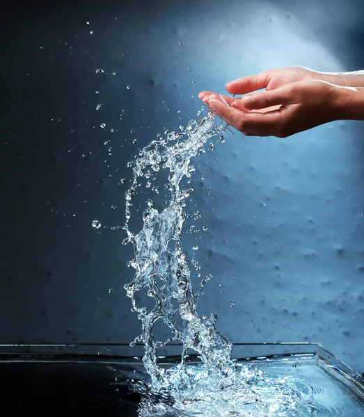 Female hands with water splashing — Stock Photo, Image