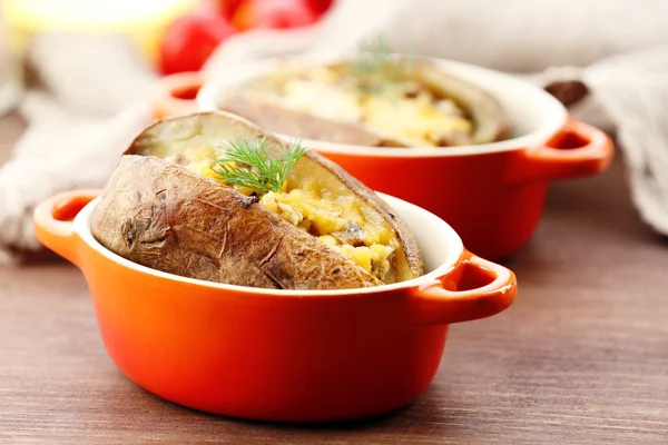Baked potatoes with cheese and mushrooms on table close up — Stock Photo, Image