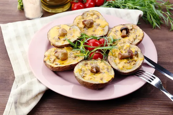 Baked potatoes with cheese and mushrooms on table close up — Stock Photo, Image