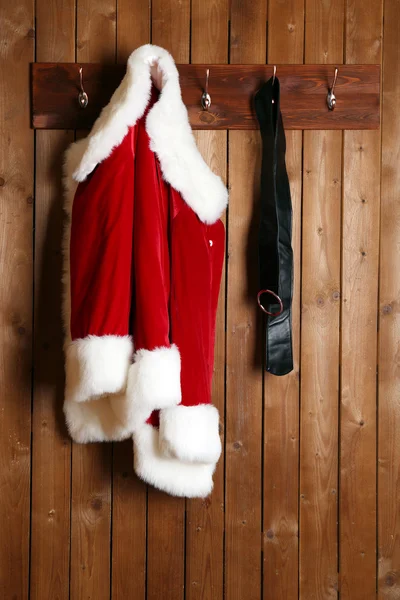 Santa costume on wooden wall — Stock Photo, Image