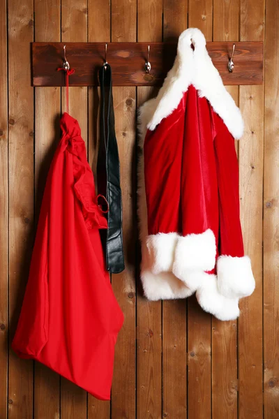 Santa costume on wooden wall — Stock Photo, Image