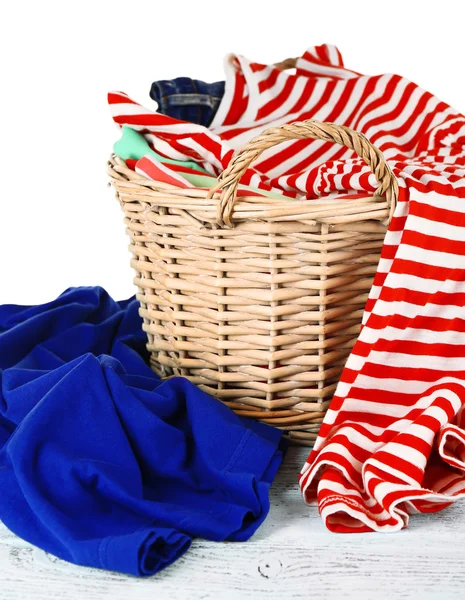 Colorful clothing in wicker basket Stock Photo