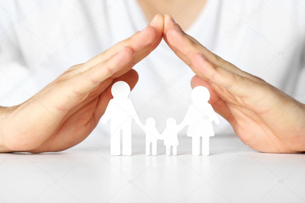 Figurine of family in male hands