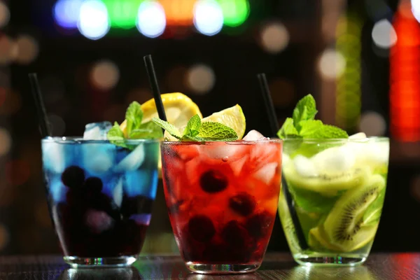 Glasses of cocktails in bar on bright blurred background — Stock Photo, Image