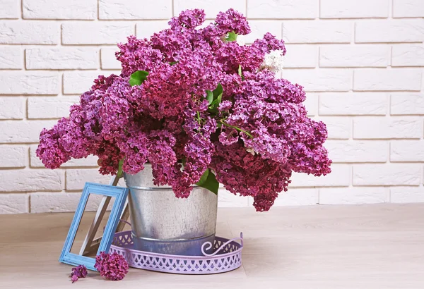 Beautiful lilac flowers in pail — Stock Photo, Image