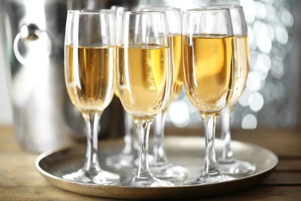 Glasses of champagne on bright background — Stock Photo, Image