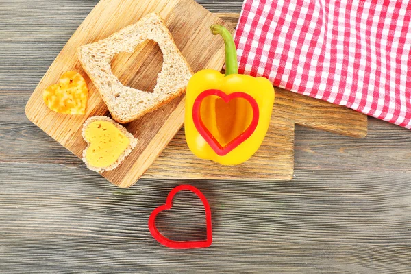 Bread slice with cut in shape of heart — Stock Photo, Image
