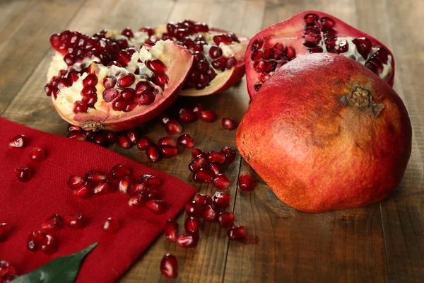 Pomegranate seeds on wooden table — Stock Photo, Image