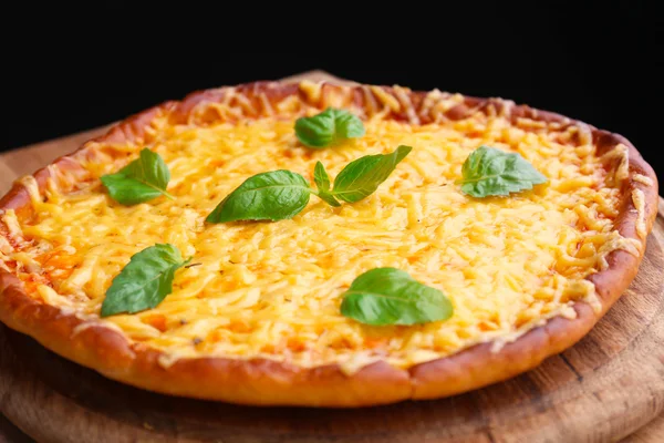 Tasty cheese pizza with basil — Stock Photo, Image