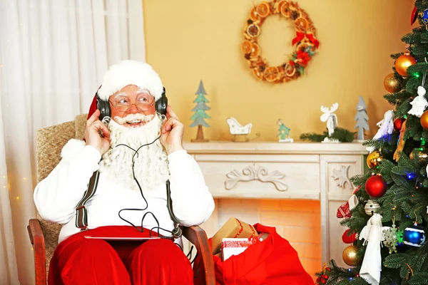 Santa Claus sitting with Digital tablet — Stock Photo, Image