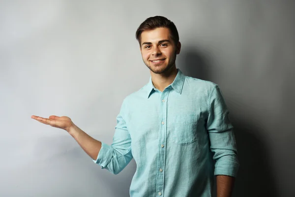 Handsome man holding copy space — Stock Photo, Image