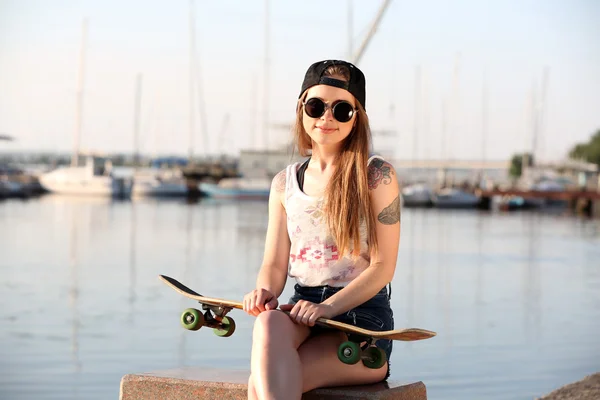 滑板，在户外的漂亮纹身的女孩 — 图库照片