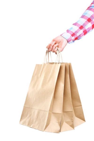 Hand som håller papper shoppingväska — Stockfoto