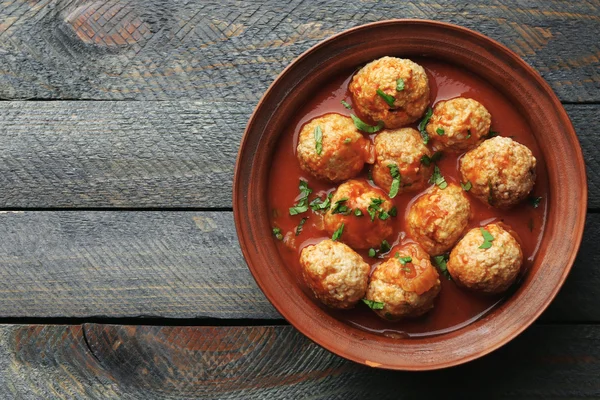 Bolas de carne com molho de tomate, em fundo de madeira — Fotografia de Stock