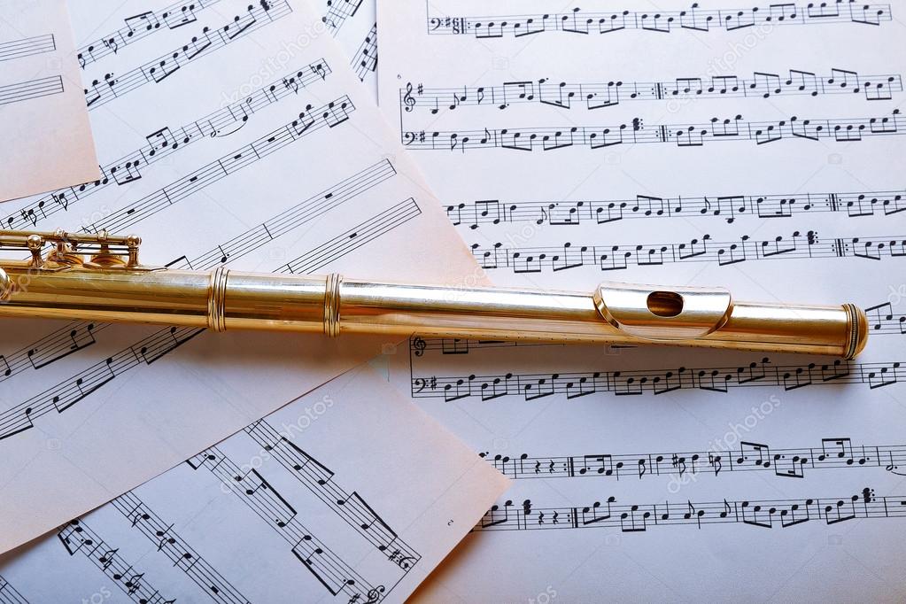 Flute on music notes Stock Photo by ©belchonock 79064664