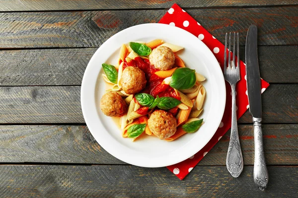 Pasta with meatballs on plate, on wooden  table background — Stock Photo, Image